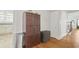 Hallway featuring hardwood floors, a large cabinet, and access to the kitchen at 104 East Bay St., Georgetown, SC 29440