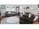 Spacious living room featuring hardwood floors, a fireplace, and comfortable seating with views of the outdoors at 104 East Bay St., Georgetown, SC 29440