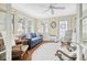 Cozy sunroom with a comfortable sofa, vintage rocking chairs, and natural light streaming through the windows at 104 East Bay St., Georgetown, SC 29440