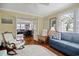 Cozy living room showcasing hardwood floors, a round rug, and comfortable seating with great natural light at 104 East Bay St., Georgetown, SC 29440