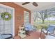 Inviting screened porch featuring brick accents, comfortable seating, and lovely exterior views at 104 East Bay St., Georgetown, SC 29440