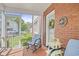 Relaxing screened-in porch with comfortable seating and a view of the surrounding landscape at 104 East Bay St., Georgetown, SC 29440