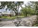 Neighborhood street showcasing traditional brick homes and mature trees, creating a welcoming atmosphere at 104 East Bay St., Georgetown, SC 29440