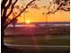 Scenic sunset view overlooking a tranquil body of water with trees silhouetted in the foreground at 104 East Bay St., Georgetown, SC 29440