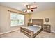 Bedroom features a rustic wood bed frame, neutral walls, and a ceiling fan at 109 Butkus Dr. # 2-1, Myrtle Beach, SC 29588
