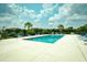 Relaxing community pool with ample seating, palm trees, and a clear blue swimming pool at 109 Butkus Dr. # 2-1, Myrtle Beach, SC 29588