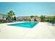 Gorgeous community pool with several lounge chairs, palm trees, and residential buildings surrounding it at 109 Butkus Dr. # 2-1, Myrtle Beach, SC 29588