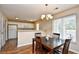 Inviting dining area featuring a wooden table, chandelier, and a view into the kitchen at 109 Butkus Dr. # 2-1, Myrtle Beach, SC 29588