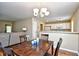 Cozy dining room with a dark wood table, decorative chandelier, and adjacent living area at 109 Butkus Dr. # 2-1, Myrtle Beach, SC 29588