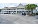 Accessible condo building featuring a ramp and ample parking near palm trees at 109 Butkus Dr. # 2-1, Myrtle Beach, SC 29588
