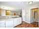 Open-concept kitchen featuring white appliances, laminate countertops, and view to dining area at 109 Butkus Dr. # 2-1, Myrtle Beach, SC 29588