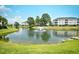 Beautiful community pond with a fountain surrounded by lush greenery and residential buildings at 109 Butkus Dr. # 2-1, Myrtle Beach, SC 29588