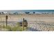 Sandy beach with views of the ocean, beach umbrellas, and lounge chairs perfect for relaxation and recreation at 1212 Ocean Blvd. S # 202, Surfside Beach, SC 29575