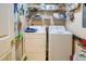 Efficient laundry room equipped with washer, dryer, and shelving for storage and organization at 1212 Ocean Blvd. S # 202, Surfside Beach, SC 29575