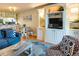 Open living area with stylish furnishings, built-in shelving and cabinets, and adjacent dining area at 1212 Ocean Blvd. S # 202, Surfside Beach, SC 29575