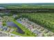 Aerial view of a quiet street in the Prince Creek community, surrounded by lush green trees and a pond at 1227 Cypress Shadow Ct., Murrells Inlet, SC 29576