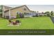 Spacious fenced backyard with lush green grass and a cozy fire pit area for outdoor enjoyment at 1227 Cypress Shadow Ct., Murrells Inlet, SC 29576