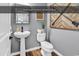 Downstairs half bathroom with stylish pedestal sink, classic toilet, and wood-look flooring at 1227 Cypress Shadow Ct., Murrells Inlet, SC 29576