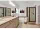 Bright bathroom featuring a double vanity with stone countertops, tiled floors, and a glass-enclosed shower at 1227 Cypress Shadow Ct., Murrells Inlet, SC 29576