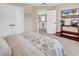 Cozy bedroom with a floral comforter, television, and doorway leading to the upper level of the home at 1227 Cypress Shadow Ct., Murrells Inlet, SC 29576