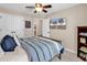 Bedroom featuring a striped comforter, television, and doorway leading to another room at 1227 Cypress Shadow Ct., Murrells Inlet, SC 29576