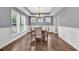 Bright dining room featuring hardwood floors, white wainscoting, and a modern chandelier at 1227 Cypress Shadow Ct., Murrells Inlet, SC 29576