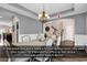 Formal dining room with tray ceiling, wainscoting, modern chandelier, and hardwood floors at 1227 Cypress Shadow Ct., Murrells Inlet, SC 29576