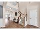 Grand foyer with hardwood floors, staircase with white railings, and a view into the living spaces at 1227 Cypress Shadow Ct., Murrells Inlet, SC 29576