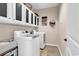 Laundry room featuring white cabinets above a side-by-side washer and dryer set at 1227 Cypress Shadow Ct., Murrells Inlet, SC 29576