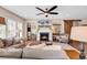 Cozy living room features a fireplace, ceiling fan, and comfortable seating at 1227 Cypress Shadow Ct., Murrells Inlet, SC 29576