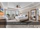Airy main bedroom with tray ceiling, windows, and luxurious furnishings at 1227 Cypress Shadow Ct., Murrells Inlet, SC 29576