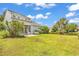 Expansive backyard features lush green grass, mature trees, and a view of the property's screened-in porch at 126 Dreamland Dr., Murrells Inlet, SC 29576