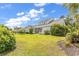 Large backyard features lush landscaping, mature trees, and the home's screened-in porch at 126 Dreamland Dr., Murrells Inlet, SC 29576