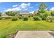 Well-manicured backyard with lush green grass and mature landscaping offers a serene outdoor space at 126 Dreamland Dr., Murrells Inlet, SC 29576