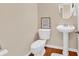 Cozy bathroom with a pedestal sink, toilet, and stylish framed artwork at 126 Dreamland Dr., Murrells Inlet, SC 29576