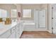 Bright bathroom features a double vanity, walk-in shower, and tiled floors at 126 Dreamland Dr., Murrells Inlet, SC 29576