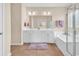 Bright bathroom features a double vanity, a soaking tub with shower, and tiled floors at 126 Dreamland Dr., Murrells Inlet, SC 29576