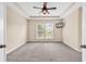 Spacious bedroom with neutral carpet, tray ceiling, and two large windows at 126 Dreamland Dr., Murrells Inlet, SC 29576