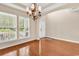 Bright dining room with hardwood floors, a modern chandelier, and large windows with outdoor views at 126 Dreamland Dr., Murrells Inlet, SC 29576