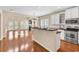 Spacious kitchen featuring white cabinets, stainless steel appliances, and hardwood floors that open to living area at 126 Dreamland Dr., Murrells Inlet, SC 29576