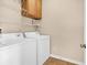Functional laundry room with washer, dryer, storage shelf, and neutral tile floors at 126 Dreamland Dr., Murrells Inlet, SC 29576