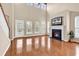 Cozy living room with vaulted ceilings, hardwood floors, a fireplace, and multiple windows at 126 Dreamland Dr., Murrells Inlet, SC 29576