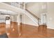 Open-concept living room with hardwood floors, staircase, and seamless flow to other areas at 126 Dreamland Dr., Murrells Inlet, SC 29576