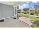 A screened-in porch overlooks a landscaped backyard and pond views at 126 Dreamland Dr., Murrells Inlet, SC 29576