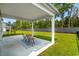 Relaxing covered patio with outdoor seating and a view of the expansive backyard at 1331 Winding Creek Way, Myrtle Beach, SC 29588