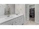 Modern bathroom with double sink vanity, white cabinets, and a tiled shower with a glass door at 1331 Winding Creek Way, Myrtle Beach, SC 29588