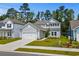 Charming two-story home with grey siding, attached garage and well-manicured lawn at 1331 Winding Creek Way, Myrtle Beach, SC 29588