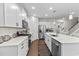 Well-lit kitchen showcases stainless steel appliances, ample white cabinets, and quartz countertops at 1331 Winding Creek Way, Myrtle Beach, SC 29588