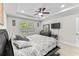 Well-lit main bedroom featuring a tray ceiling, ceiling fan, and plush carpet flooring at 1331 Winding Creek Way, Myrtle Beach, SC 29588