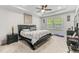Well-lit main bedroom featuring a tray ceiling, ceiling fan, and plush carpet flooring at 1331 Winding Creek Way, Myrtle Beach, SC 29588